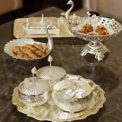 My Mijaaz collection is a tribute to Mughal grandeur, and this peacock-themed silver serveware set is its crown jewel. Each piece, from the serving tray to the lidded bowls, is crafted to bring a sense of royal artistry to your table.