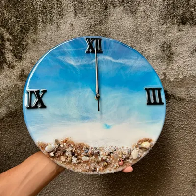 This ocean-themed wall clock is one of my most popular designs, featuring realistic waves and a beach made of actual sand and shells. The 12-inch clock has bold black Roman numerals and a silent mechanism, bringing a piece of the sea to your wall.