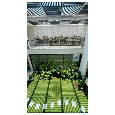 This double-height indoor courtyard in a Bangalore residence is one of our signature projects. The design allows sunlight to stream in, nourishing the lawn and tropical plants, creating a private garden that can be enjoyed from multiple levels of the home.