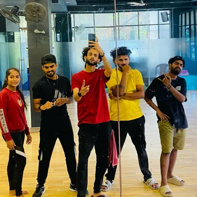 The RDI trainer team striking a pose in the mirror. We are the choreographers and artists ready to guide you on your dance journey.