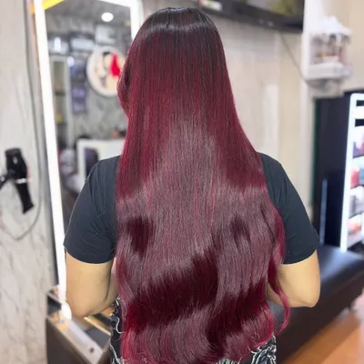 This cherry red hair is pure magic. The color is incredibly vibrant and glossy, making it the perfect bold choice for the festive Christmas season. Red is not just a color, it's a mood.