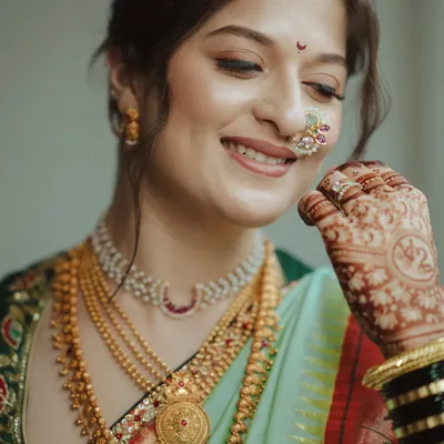 A beautiful Maharashtrian bride on her wedding day, her hair styled in a traditional updo that perfectly complements her nath and jewelry.