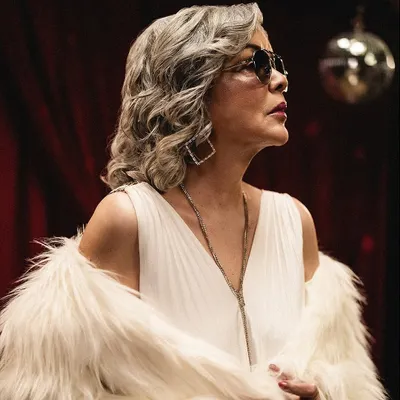 A classic retro-glam look for Zeenat Aman, featuring a white jumpsuit and a faux fur coat. This shot captures the timeless elegance and star power that I aimed to highlight through the styling.