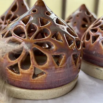 Our handmade ceramic tea light holders are perfect for the festive season. These intricate pieces create a beautiful, warm glow for Diwali.