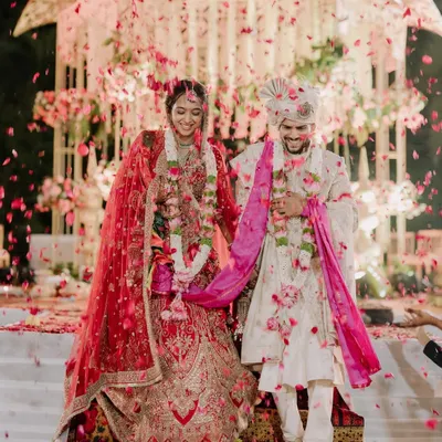 A grand exit showered in petals. We capture the magnificent scale and joyous atmosphere of North Indian wedding celebrations.