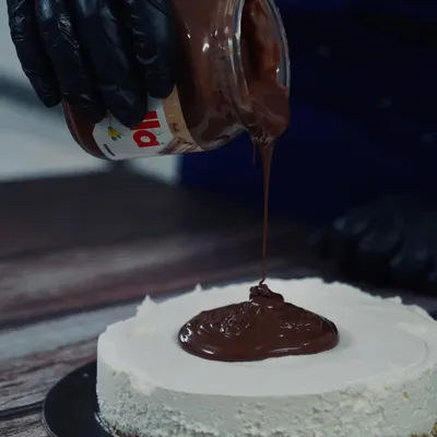 That Nutella pour is everything. My eggless Nutella cheesecake is a crowd-pleaser, featuring a crunchy biscuit base, a light cream cheese filling, and a thick, decadent layer of pure Nutella.