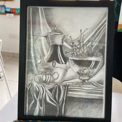 A stunning still life sketch created by a student in our short-term course. Notice the incredible detail in the reflections and fabric folds.