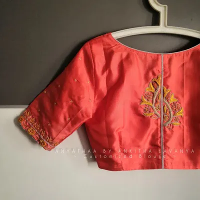A simple yet elegant custom embroidered blouse I designed for a client. This peach silk blouse features delicate embroidery on the sleeves and a motif on the back.
