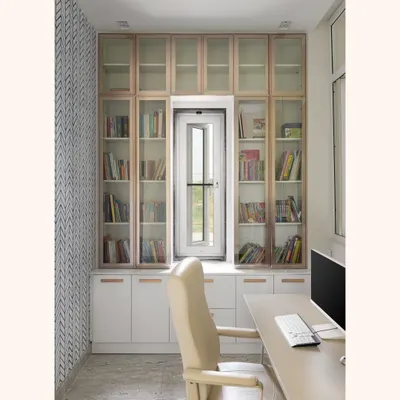 This is the final look of the study nook, built around a window to maximize natural light. The floor-to-ceiling library provides ample book storage, with a mix of glass-fronted and closed cabinets in a two-tone finish.