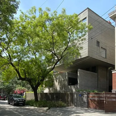 The Jenga House in New Delhi, viewed from the street. The design's name comes from its stacked, cantilevered concrete forms that create a powerful sculptural presence within its urban context.