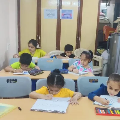 A classroom buzzing with creativity. Our young artists are deeply focused on their drawings, learning sketching and coloring techniques with guidance from our art instructors.