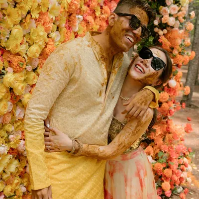 This is what I call sunshine chic. For this haldi, we created a stunning floral wall with an ombre of marigolds and roses, a modern twist on a traditional ceremony that perfectly matched the couple's vibrant energy.