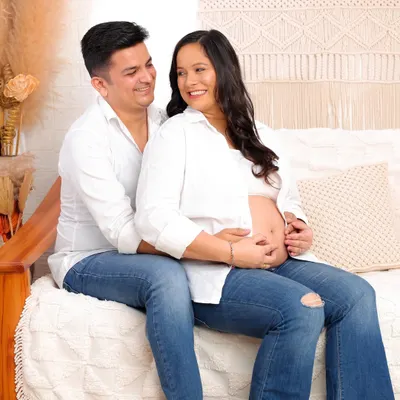 A perfect example of a relaxed casual session. This couple, dressed in simple jeans and white shirts, shares a laugh in my cozy, boho-themed studio.