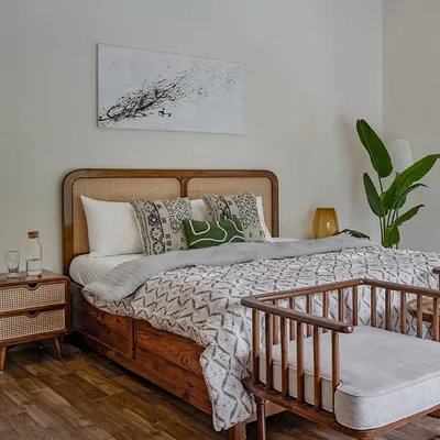 A beautiful bedroom setting featuring my mid-century modern bed with a curved cane and wood headboard. The matching cane nightstand completes this serene and stylish space.