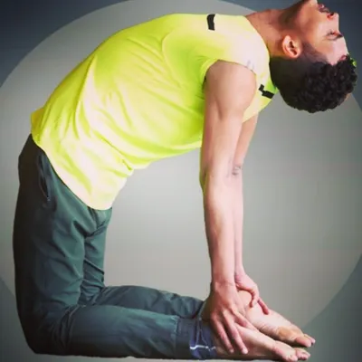 A close-up of the Ustrasana (Camel Pose), a powerful heart-opening backbend. This pose is excellent for improving spinal flexibility and strengthening the back muscles, which is key for correcting posture after long hours of sitting.