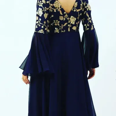 The back view of the navy blue georgette gown, showing the V-neckline and the continuation of the gold floral embroidery across the shoulders.