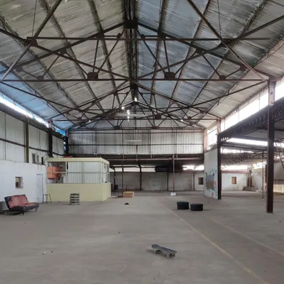 A stark "before" picture of the empty, cavernous warehouse before our transformation began, showing the raw potential of the space.