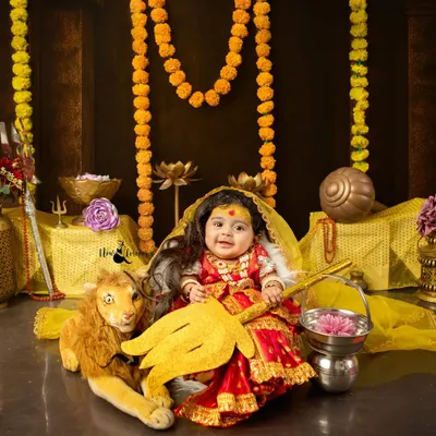 A masterpiece of our Navratri celebration, this little girl is transformed into a divine Durga. The detailed costume, props, and her innocent expression create a truly powerful portrait.