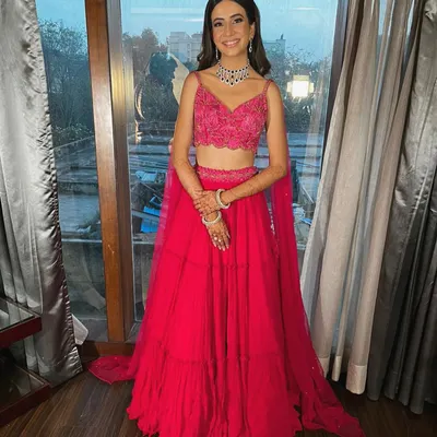 A full-length shot of Rhea's gorgeous engagement outfit. The tiered fuchsia skirt creates beautiful movement, while the intricately embroidered blouse adds a touch of sparkle.