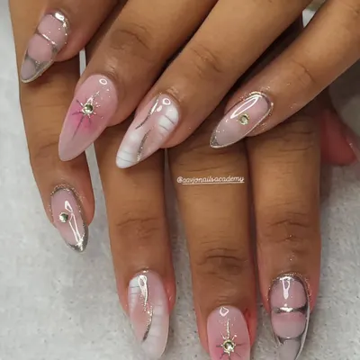 A beautiful example of Korean-inspired nail art. This set features a soft pink base with a blush effect, marble accents, and delicate silver chrome lines for a chic and modern look.