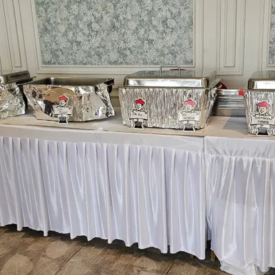 A clean and professional buffet setup for a football-themed birthday party. I provide everything from the food warmers to the table skirting.