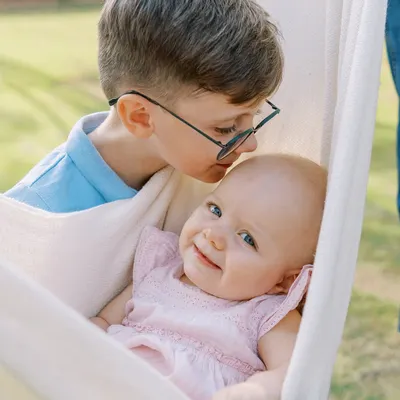 The gentle kiss of an older brother for his baby sister. These are the moments that melt my heart and create a timeless memory of sibling love.