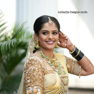 The radiant smile of our bride Monisha in her custom Anthariya wedding outfit. Her golden saree and heavily embroidered blouse were designed to make her feel as special as she is.