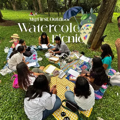 This wide view captures the essence of the picnic. A circle of new friends, surrounded by the green of Cubbon Park, all focused on their art. This is the safe and inspiring environment I strive to create.