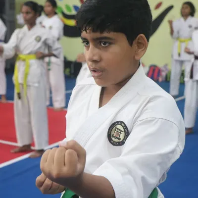 The look of pure focus. We teach our students that power comes not just from the body, but from a disciplined mind. This young warrior is practicing his basic stance and punch (Kihon).