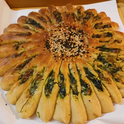This gluten-free Millet Sunflower Bread is a work of art, filled with a savory spinach and vegan cheese mixture.