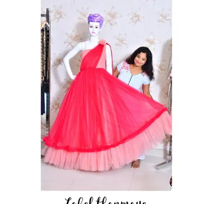 Here I am, adding the final touches to a two-tone red and pink gown in my studio.