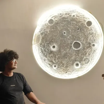I am sitting next to a large, backlit 3D moon art piece, one of the most popular items we teach. This artwork can transform any room with its serene and realistic glow.