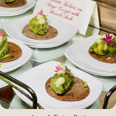 My Avocado Tartare on Ragi Crisps with Wasabi Aioli. This bite-sized canapé combines creamy avocado with the earthy crunch of ragi and a kick of wasabi, garnished with an edible flower.