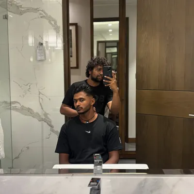 A typical pre-event haircut session with Sai Sudharsan in his hotel room. My mobile grooming setup allows me to provide a full-service experience anywhere.