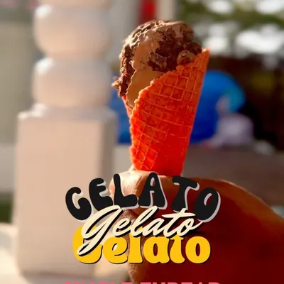 A perfect scoop of our handcrafted gelato served in a vibrant red waffle cone. This image captures the simple joy of a high-quality, delicious dessert, perfect for any occasion.