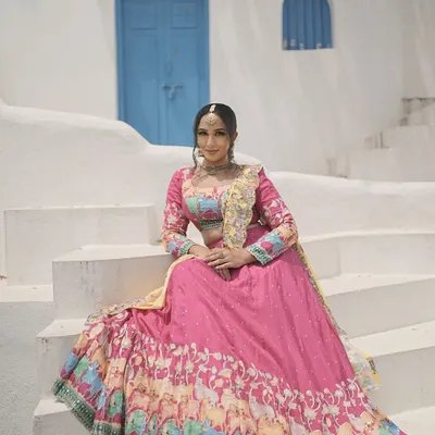 A Navratri series photoshoot with a vibrant, festive theme. The makeup is bright and celebratory, matching the colorful lehenga and the joyous spirit of the festival.