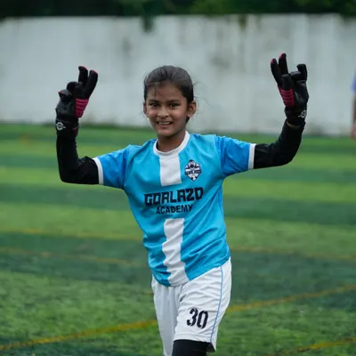 A happy and confident goalkeeper, ready for action. We train every position with specialized attention.