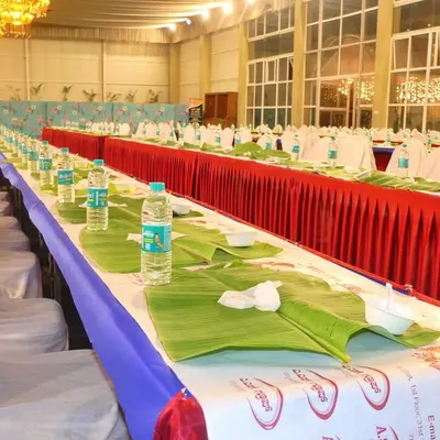 The calm before the feast. This shows our meticulous preparation for a large-scale pangat service, with banana leaves and water bottles neatly arranged for hundreds of guests at an engagement event.