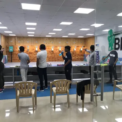 A wide view of our 10-meter indoor shooting range during an active session. The space is well lit and designed for a safe and organized shooting experience.