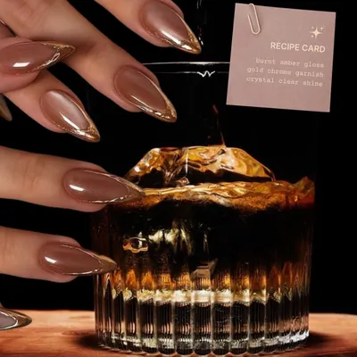 Not on the rocks, but definitely on the nails. This fall cocktail-inspired set features "burnt amber glass" nails with a gold chrome garnish.