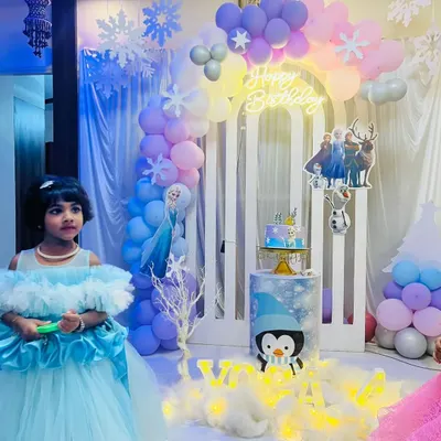 A beautiful home-based setup for a Frozen themed birthday party. We used a pastel balloon arch, a custom neon "Happy Birthday" sign, and character cutouts to transform the space into a winter wonderland.