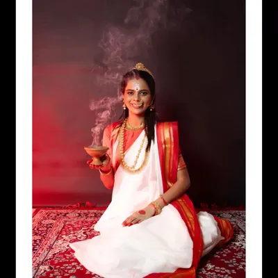A powerful portrait from my Durga Puja conceptual shoot. The model, dressed in a traditional white and red saree, holds a 'dhunuchi' with fragrant smoke, evoking a divine and spiritual atmosphere.