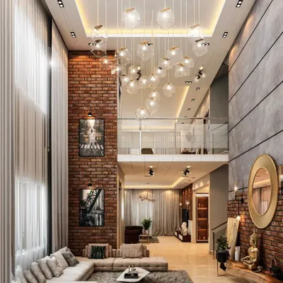 This duplex living room showcases our ability to design for grand, double-height spaces. The exposed brick wall adds an industrial-chic texture, while the cluster of pendant lights draws the eye upward, creating a space that is both impressive and inviting.