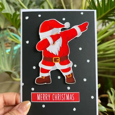 Embrace the holiday season with my handmade Christmas cards! This one features a fun, dabbing Santa to bring a smile to anyone's face.
