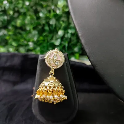 A delicate and pretty jhumka with pink enamel work on the top, perfect for a daytime event.