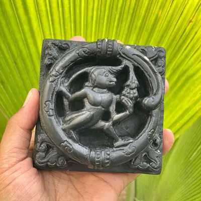 This unique, handcrafted wall plaque shows a monkey relishing grapes, a design inspired by the temple walls of India and carved from Krishna shila stone.