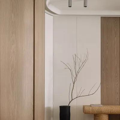 The entrance to Kanso House sets a tone of calm simplicity. We used clean lines, natural wood, and a single, sculptural branch to create a moment of pause, inviting you to leave the city's rush behind and step into a space of tranquility.