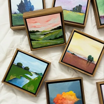 A collection of my miniature landscape paintings, each framed and ready to bring a small moment of scenery into a home. These small canvases are painted with just as much heart as my large murals.