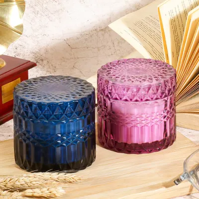A vintage and academic inspired setting for these decorative jar candles. The old books and gramophone create a cozy, studious atmosphere, suggesting these candles are perfect for a reading nook or study.