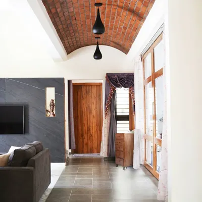 An exposed brick vault ceiling creates a stunning architectural feature in the main hallway. This technique adds warmth, texture, and a sense of movement to the space.